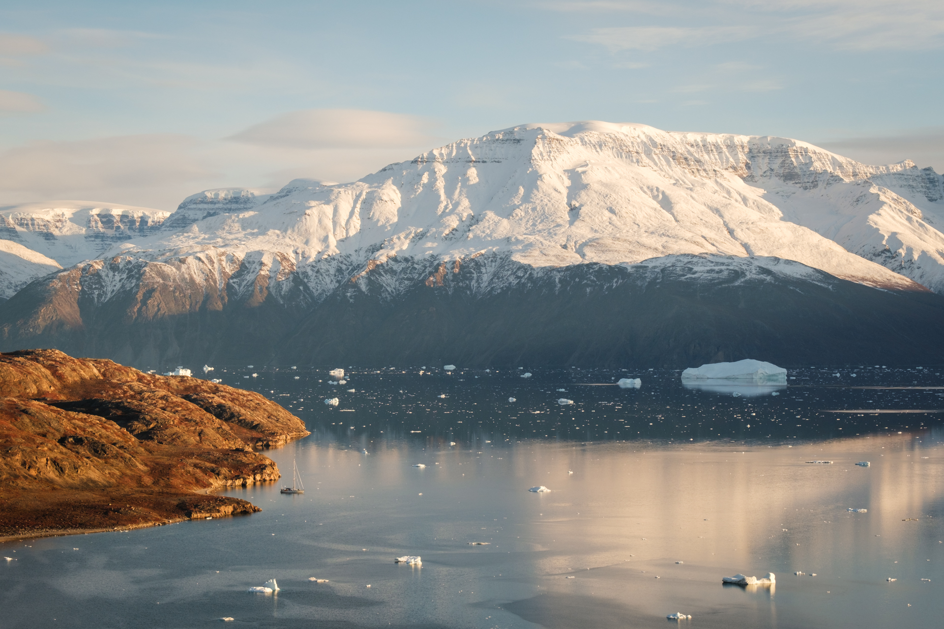 Sailing yacht surrounded by mountains in Scoresbysund.